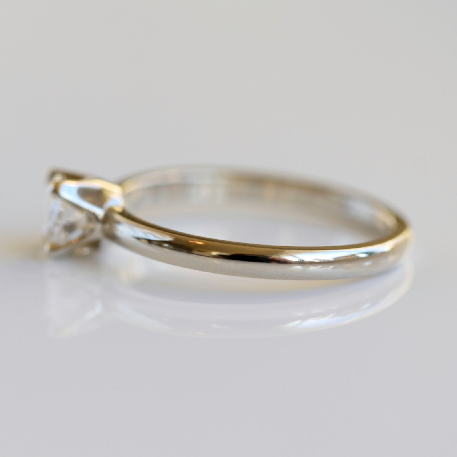 Solitaire engagement ring with a prong-set white diamond. The center stone is around 5mm in diameter.