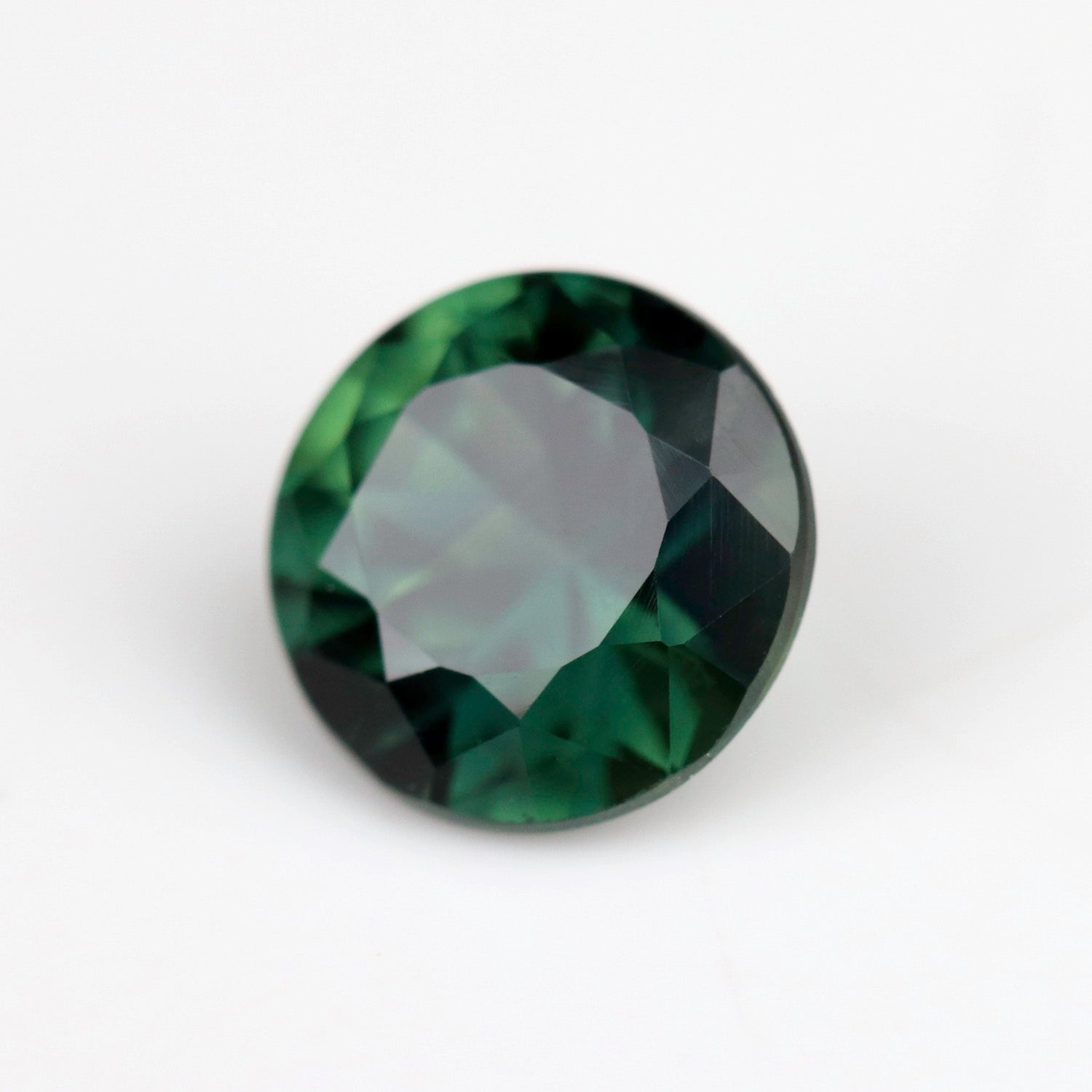 A round brilliant Australian sapphire in a 5mm diameter size. The stone is a saturated olive green tone.