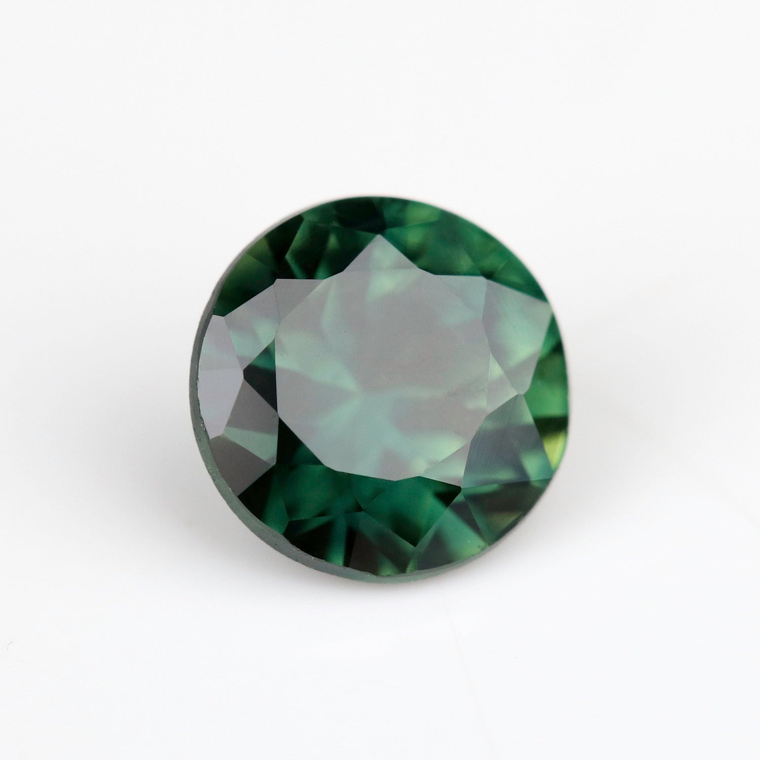 A round brilliant Australian sapphire in a 5mm diameter size. The stone is a saturated olive green tone.