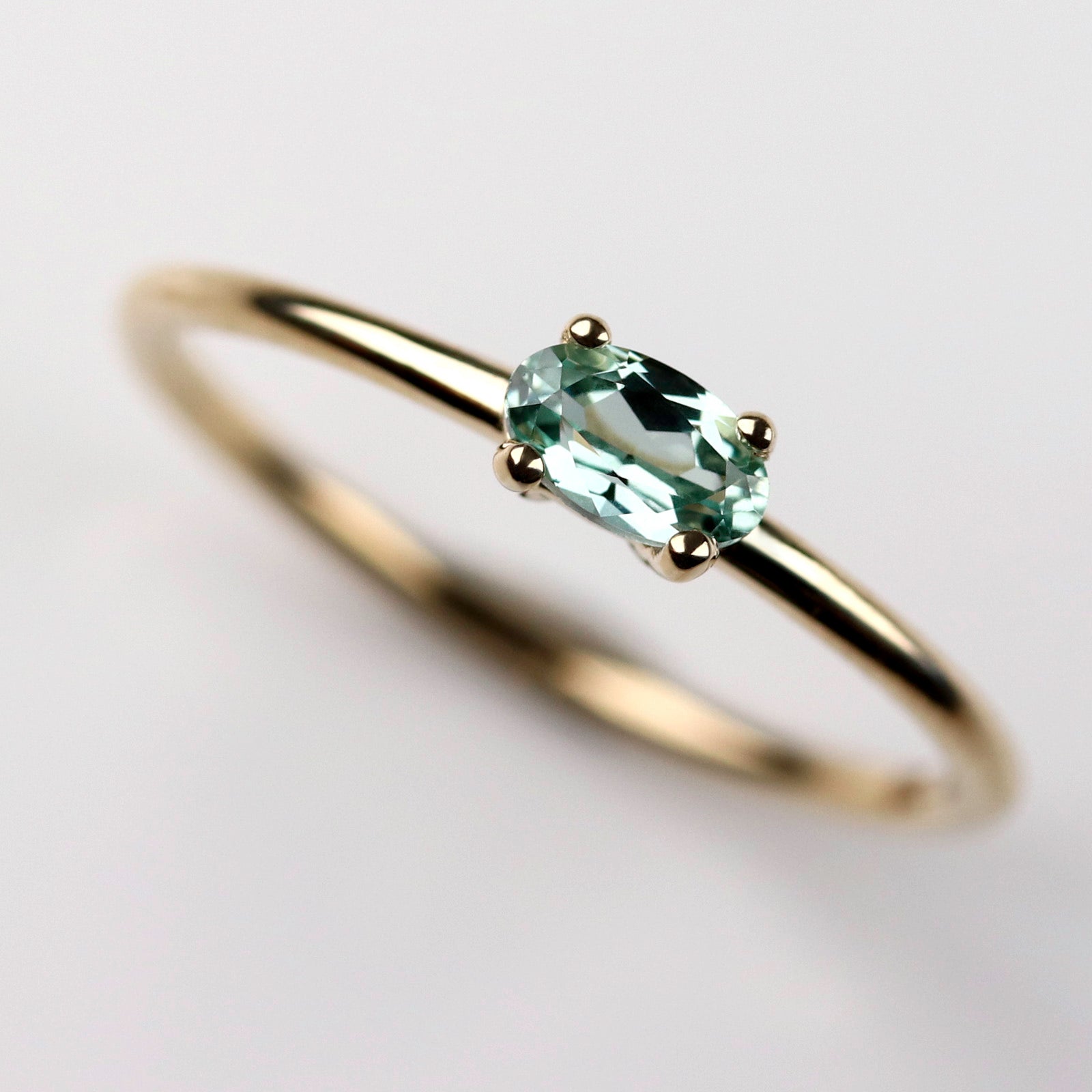 Oval cut Green Lab-grown Sapphire set East West