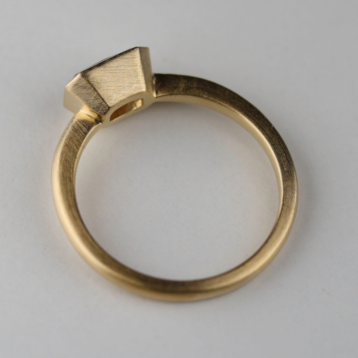 Side profile angle of a bezel set solitaire. The center setting is set in an East-West orientation.