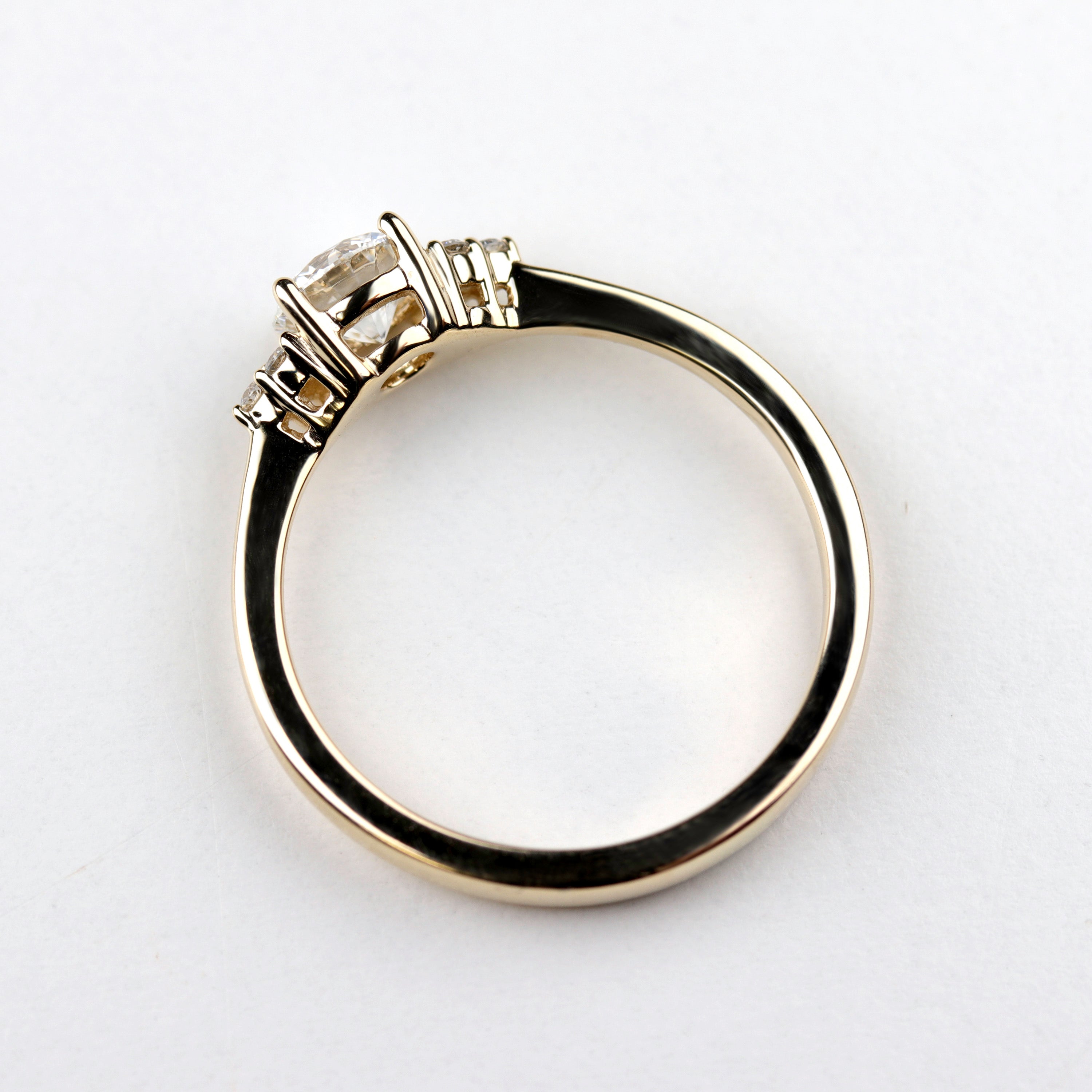 Side angle of a Seven Stone Cluster Engagement Ring style in shiny yellow gold.