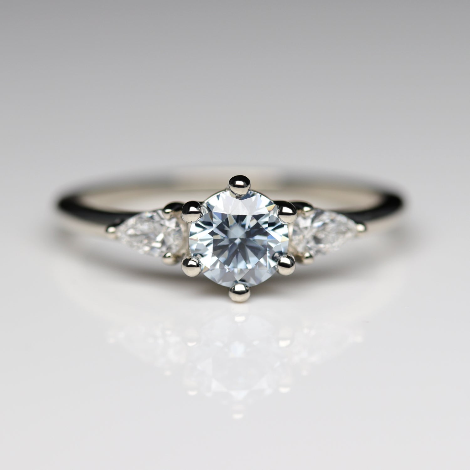 Prong-set Three Stone Ring with Light Blue Moissanite