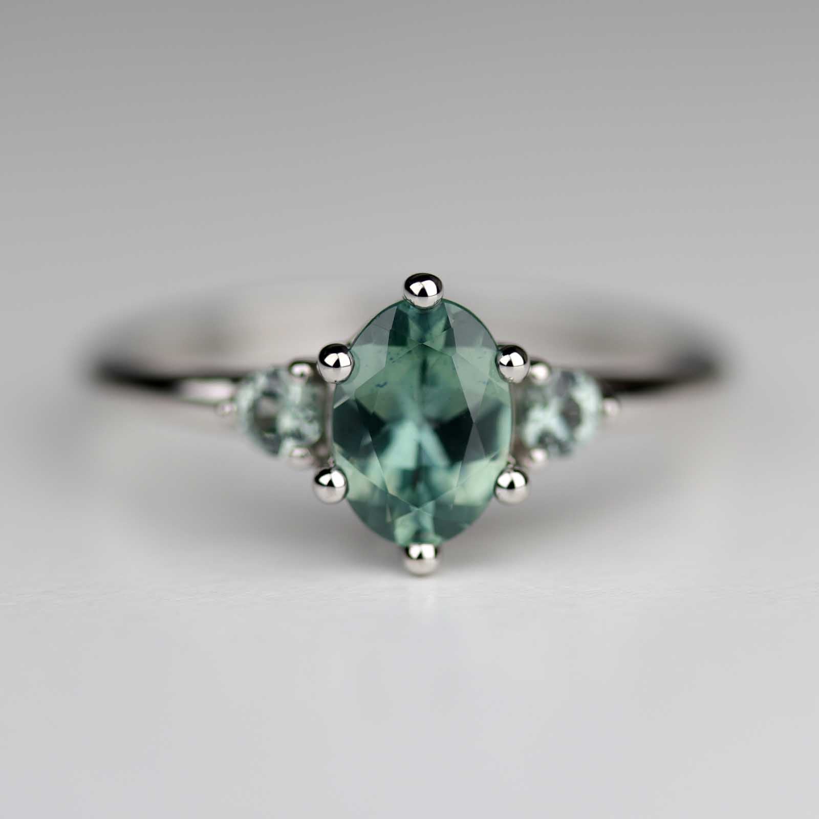 7x5mm Oval Teal Sapphire Three Stone Platinum Ring