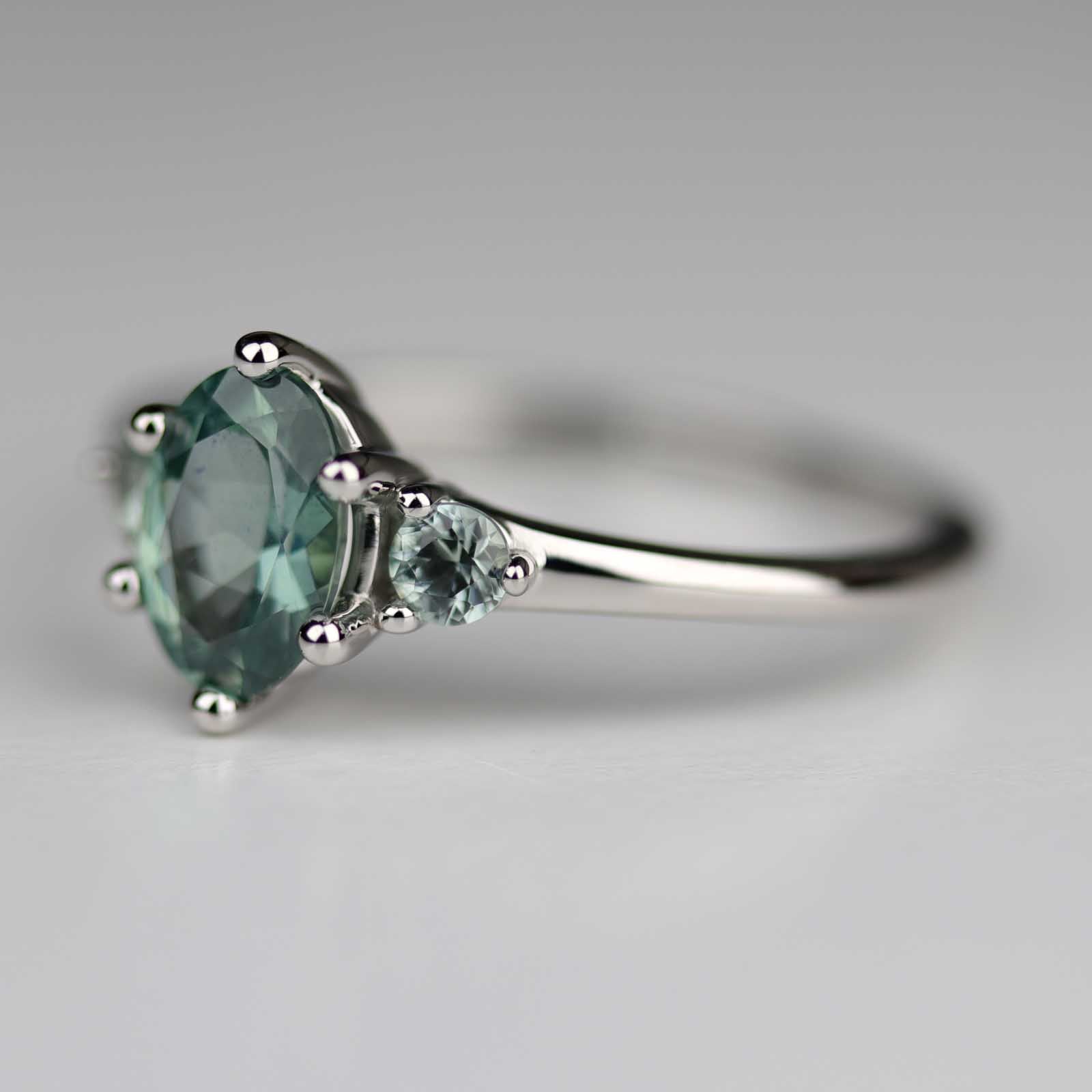 7x5mm Oval Teal Sapphire Three Stone Platinum Ring