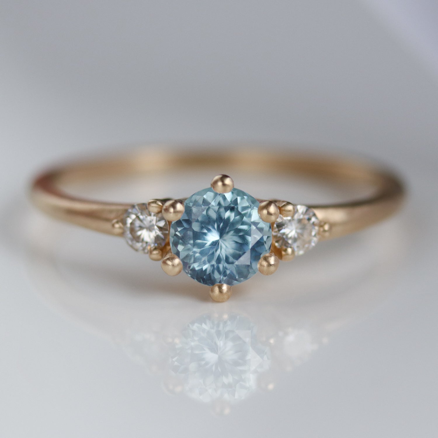 Prong-set Three Stone Ring with Montana Sapphire Center Stone