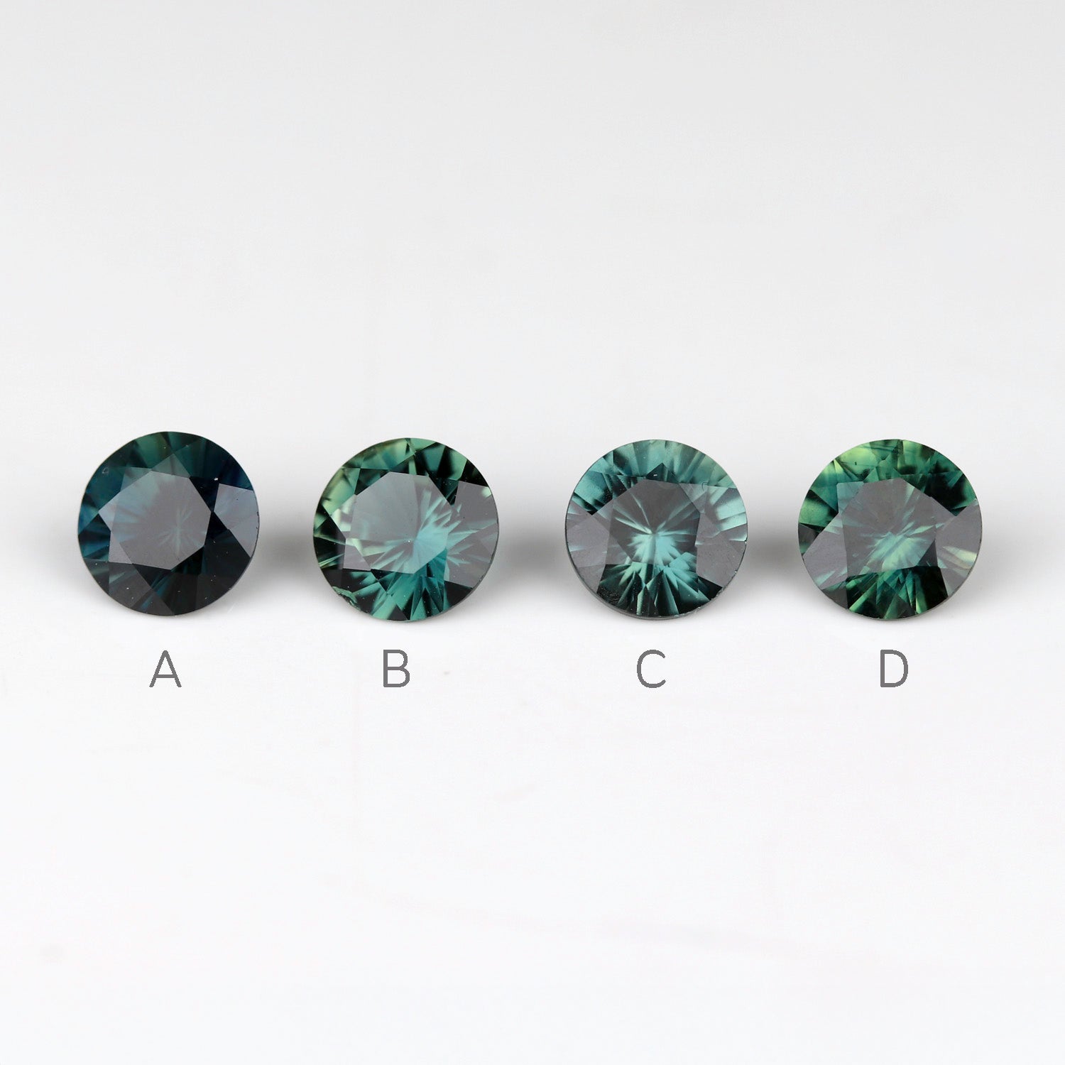 Teal Australian sapphires in a 4mm diameter size. Stones are labelled from left to right.