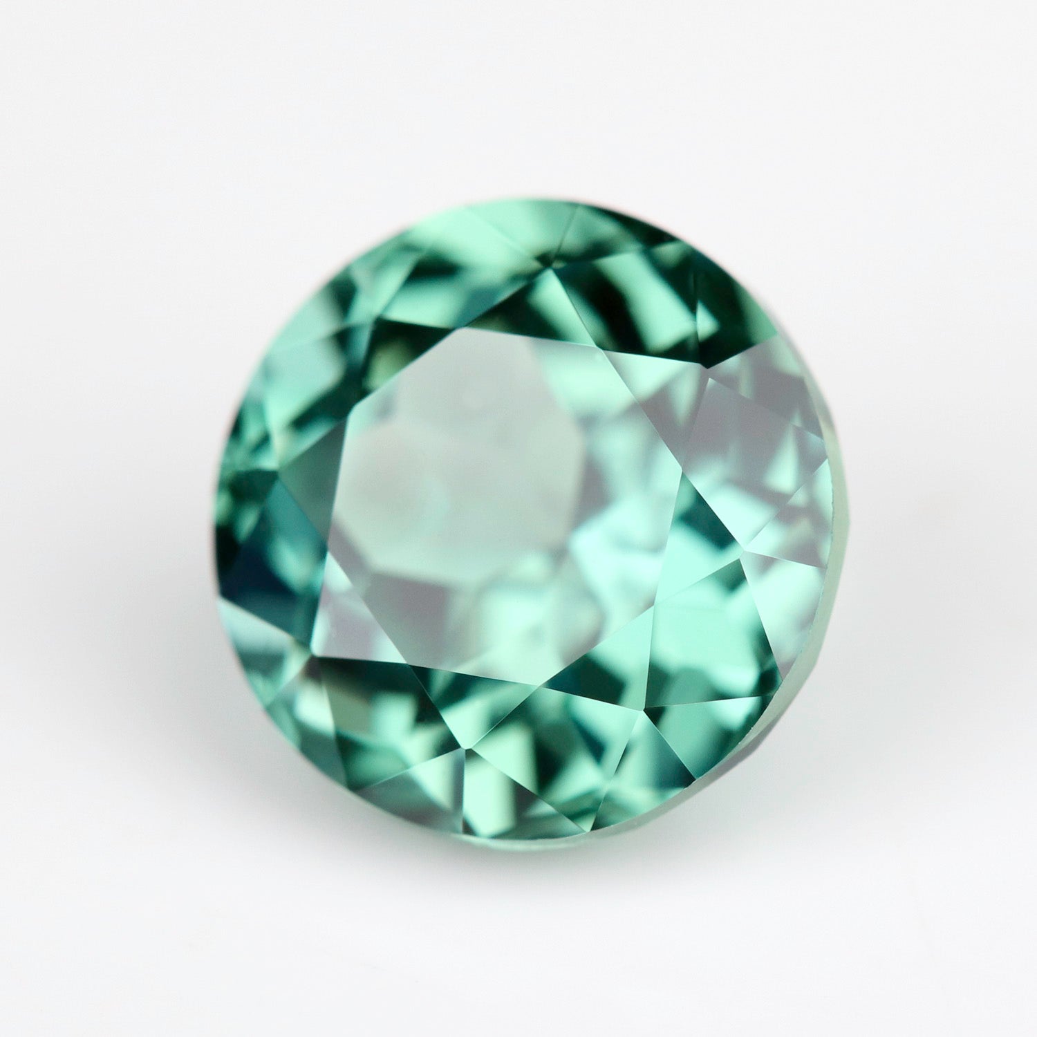 A 7mm round lab-grown green sapphire.