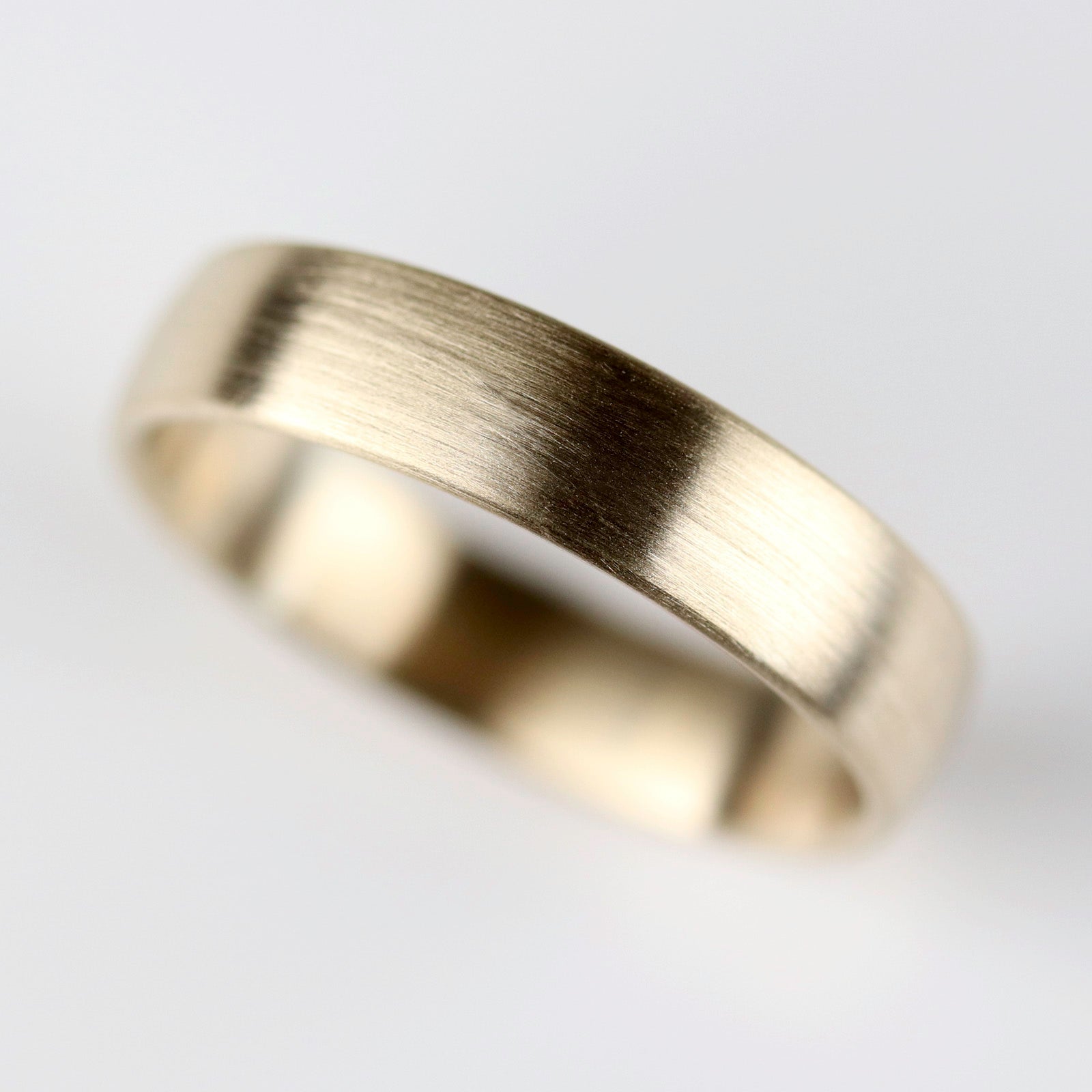 A smooth masculine or transmasculine yellow gold band. 