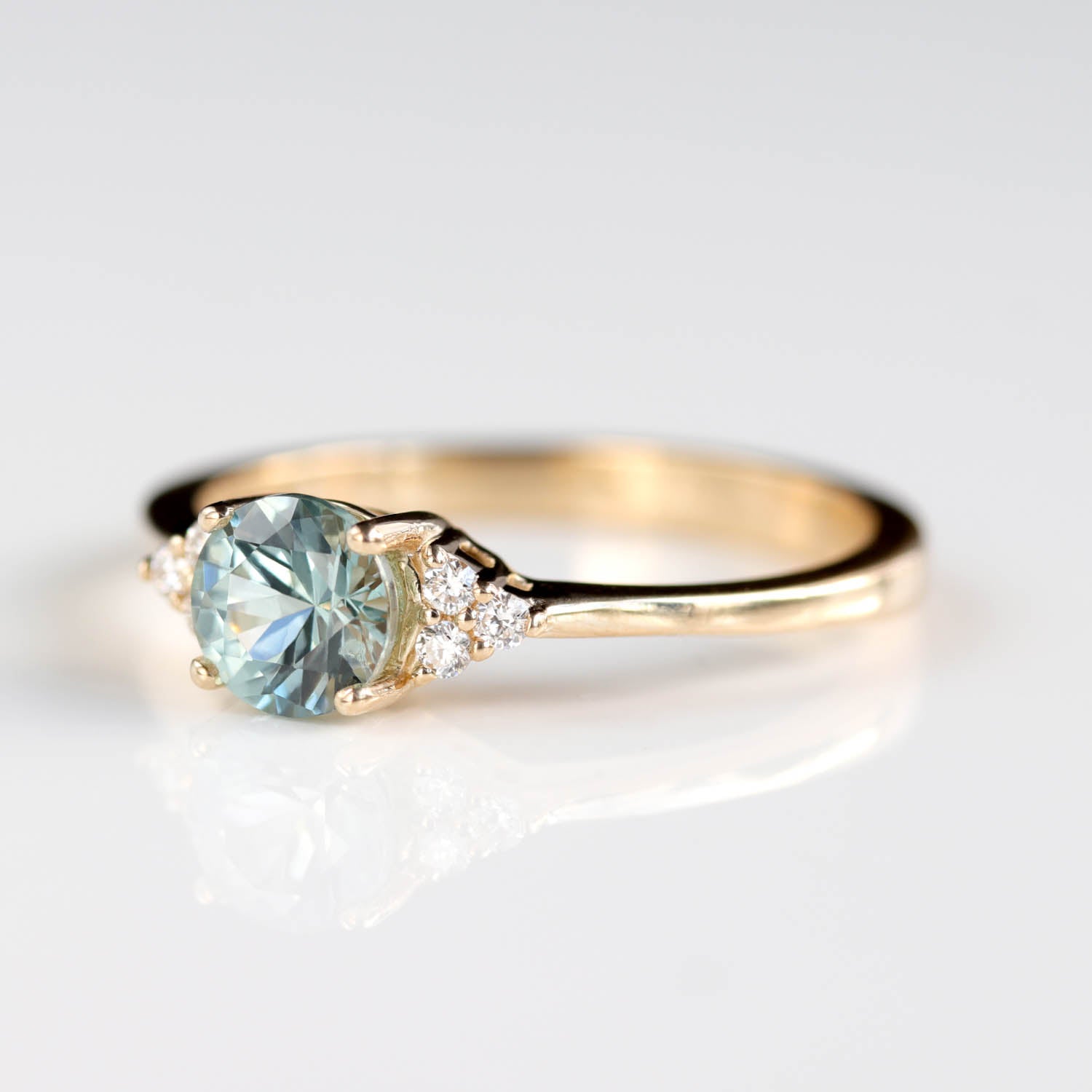 Seven Stone Basket Cluster Engagement Ring with a 5mm Malawi Sapphire